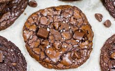 chocolate cookies with sea salt on top and one cookie in the middle, surrounded by other cookies