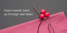 a pink piece of fabric with two red buttons on it and the words insert needle back up through last bead