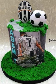 a soccer themed birthday cake with an image of a player on it and a soccer ball