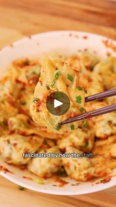 a white bowl filled with food and chopsticks sticking out of the meatballs