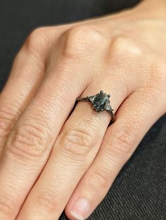 a woman's hand with a diamond ring on it