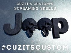 two black skulls sitting on top of a metal surface next to the words jcp