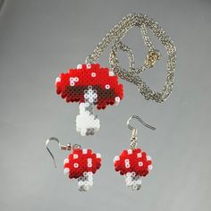 a red mushroom necklace and earring set on a silver plated chain with matching earrings