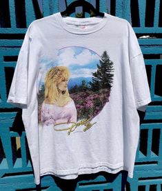 "Beautiful and rare, vintage Dolly Parton tee featuring image of Dolly from her 1995 short film, 'Heartsong' for her Dollywood theme park. In excellent vintage condition. no holes or tears. Almost perfect except for very small blue paint mark. Tag size XL, fits Women's XXL. Has a boxy, shorter fit. Please check length for proper fit. Pit to pit-24\" Length-27\" Use code CARADISE at checkout and save 15% on your first order when you visit ShoppersCaradise.com" Vintage Dolly Parton, Music Posters, Ozzy Osbourne, Almost Perfect, Dolly Parton, Tour Shirt, Tour T Shirts, How To Make Tshirts, Blue Paint