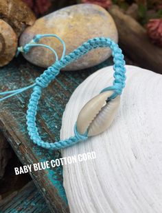 "I love the simplicity of this single cowrie shell bracelet hand knotted onto either cotton cord or waterproof polyester cord. It's just perfect for any beach lover Wear the sea on your wrist! Pretty glass seed beads will be on the closure strings. The first photo shows the addition of 2 wood beads with the cowrie shell on beige cotton cord. If you prefer the bracelet without the wood beads just leave me a message in the notes to seller section:) I hope this bracelet keeps the sea close to your Adjustable Cowrie Shell Friendship Bracelets For Vacation, Summer Beach Macrame Braided Bracelets, Beach Braided Bracelets With Macrame And Waxed Cord, Handmade Nylon Cord Friendship Bracelets For Beach, Adjustable Strand Friendship Bracelets For Beach, Handmade Friendship Bracelets With Nylon Cord For Beach, Adjustable Nylon Cord Bracelets For Beach, White Nylon Cord Bracelets For Beach, Handmade Adjustable Braided Bracelets For Vacation