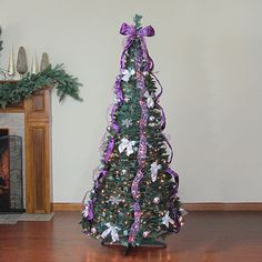 a decorated christmas tree sitting on top of a hard wood floor