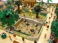 a lego model of a zoo with animals and people