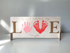 a wooden sign that says, my first valentine's day love is for you