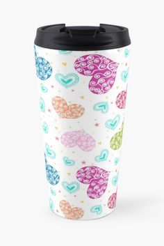 a travel mug with hearts on it and stars around the cup is shown in multi - colored