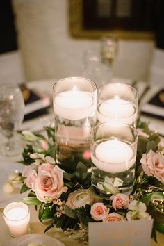 the centerpiece is filled with candles and flowers