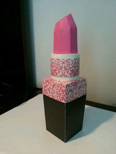 three boxes stacked on top of each other with pink and white paper in the middle