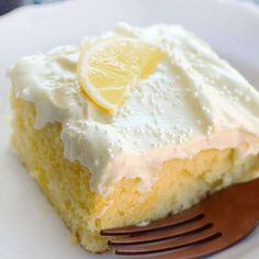 a slice of lemon cake on a plate with a fork