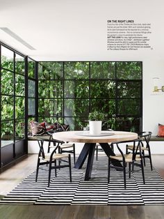 a dining room with black and white stripes on the floor, windows, and table