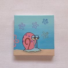 a small square tile with a cartoon snail on it