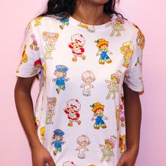 Strawberry Shortcake and Friends AOP T-Shirt - Cakeworthy Playful Short Sleeve T-shirt With All Over Print, Playful Unisex T-shirt With Character Print, Playful Cartoon Print Crew Neck T-shirt, Playful Crew Neck T-shirt With Cartoon Print, Fun Character Print T-shirt, Playful White Top With All Over Print, Cute Unisex Cartoon Print Tops, Cute Cartoon Print T-shirt, Cute All Over Print Crew Neck T-shirt