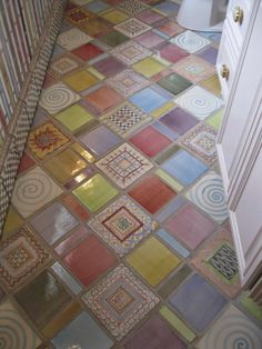 a bathroom with multicolored tiles on the floor