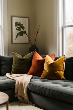 Velvet pillows on a dark sectional couch Green Couch Yellow Pillows, Green Couch With Throw Pillows, Olive Green And Mustard Living Room, Colourful Pillows Couch, Olive And Orange Living Room, Green Couch With Pillows, Mustard Pillows Living Rooms, Grey Couch Green Pillows, Burnt Orange And Green Living Room