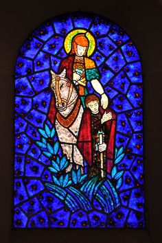 a stained glass window with a person on a horse