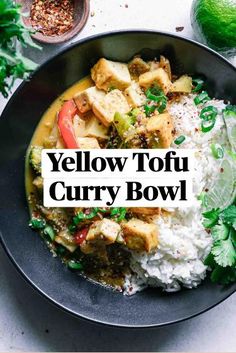 a bowl filled with rice, tofu and cilantro on top of a table