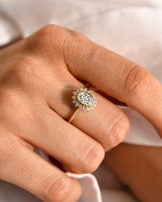 a woman's hand with a diamond ring on it