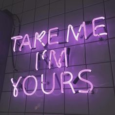 a neon sign that says take me i'm yours on the wall next to a tiled floor