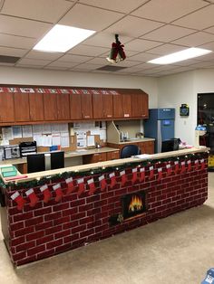 an office decorated for christmas with a fireplace