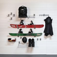 there are snowboards and skis hanging on the wall