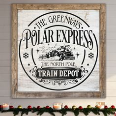 a wooden sign that says the greenways polar express and train depot with candles in front of it