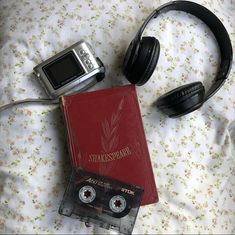 there are headphones, an mp3 player and a book on the bed