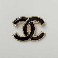 Introducing The Timeless Elegance Of The Chanel Cc Brooch. Meticulously Crafted With A Black Enamel Inlay, This Iconic Piece Features Exquisite Light Gold Trim Detailing. Versatile And Chic, It Effortlessly Elevates Any Ensemble, Whether Adorning A Coat, Jacket, Bag, Scarf, Or Hair Accessory. Embrace Sophistication With This Enduring Classic From Chanel. Brand New In Box. Final Sale. Please Ask Questions Before Purchasing. Chanel Pin, Chanel Pins, Cc Brooch, Chanel Cambon, Bag Scarf, Chanel Brooch, Chanel Camellia, Jewelry Chanel, Chanel Brand