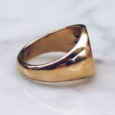 Gold toned glossy Brass Minimal Ring in sizes for both men and women. This simple ring has a circular flat face but lot's of style and flat top rings are definitely in right now! Available in 925 Sterling Silver https://etsy.me/2AZYZkU Ring Size Available in all sizes. Please be sure to find your exact ring size for the finger you want before ordering. See image chart above or you can use the chart on my website as a guide - https://jewelrylab.co/pages/ring-sizing-tips A note about brass jewelry Minimalist Oval Wide Band Ring With Polished Finish, Everyday Engraved Dome Ring, Signet Ring With Smooth Finish As Gift, Minimalist Wide Band Ring For Anniversary, Minimalist Oval Wide Band Ring For Anniversary, Round Signet Ring With Smooth Finish As Gift, Adjustable Wide Band Ring With Polished Finish, Minimalist Style, Adjustable Minimalist Wide Band Ring With Polished Finish, Minimalist Jewelry With Polished Rounded Edges