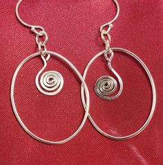 Love this sterling silver (.925) wire shape with a dangle swirl of wire.  Drop is approx 1.0 inch and so light you will forget they are swinging from your ears!!  Handmade by Ray, all Sterling to include ear wires.   #10075 Wire Wrapped Swirl Earrings, Swirl Shaped Sterling Silver Earrings For Gifts, Metal Swirl Earrings With Ear Wire, Handmade Silver Swirl Earrings, Swirl-shaped Earrings With Ear Wire, Ear Wires, Wire Jewelry, Sterling Silver Earrings, Swirl