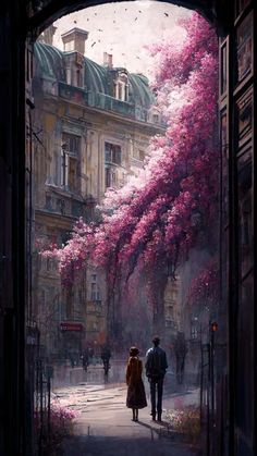 a man and woman walking down a street next to tall buildings with pink flowers on them