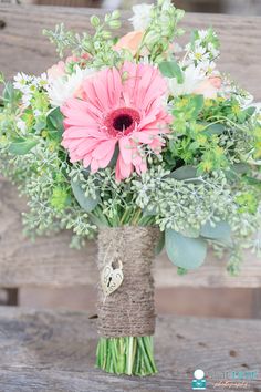 a vase filled with pink and white flowers