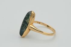 The Pasadena Victorian Moss Agate Navette Ring. The ring is bezel set in the center with a charming moval shaped cabochon moss agate. The shank is attached at the center to finish the simplistic feel of this ring. The ring is crafted in Rose gold and is signed by with the hallmark DF yet we have not identified the maker quite yet. The ring is currently a finger size 7 yet can be adjusted to any finger size. Each piece has been hand selected and meticulously identified and graded by a Graduate Ge Oval Moss Agate Gemstone Ring, Elegant Oval Moss Agate Rings, Oval Agate Hallmarked Rings, Navette Ring, Filigree Engagement Ring, Antique Diamond Rings, Yellow Gold Engagement, Filigree Ring, The Maker