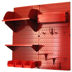 a red pegboard with shelves and bins on it