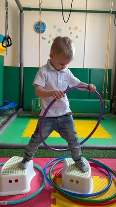 a little boy playing with some toys in a room