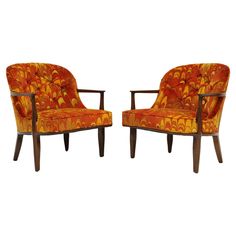 a pair of orange chairs sitting next to each other