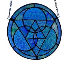 a blue stained glass window hanging from a chain