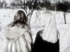 two women standing next to each other in front of trees and snow covered ground with the words winter on it