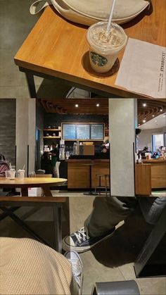 a bowl of noodles sitting on top of a wooden table next to a chair and counter