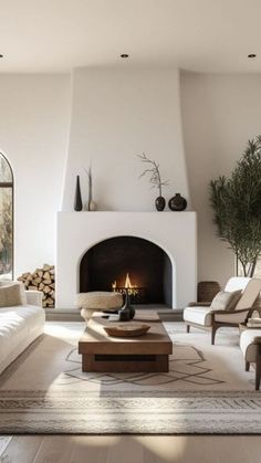 a living room filled with furniture and a fire place in the middle of a room