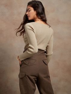 Sleek and soft, this transitional top is based on one from the Banana Republic archives, brought to life here in one of our softest, most sustainably-minded yarns.  FITTED: Stretches to fit.  SUSTAINABILITY: Made with LENZING™ ECOVERO™, a breatha Fitted Textured Knit Top, Beige Ribbed Neckline Top For Work, Beige Tops With Ribbed Neckline For Work, Ribbed Beige Tops For Workwear, Beige Ribbed Tops For Workwear, Beige Ribbed Tops For Work, Ribbed Beige Workwear Tops, Fitted Textured Knit Beige Tops, Elegant Fitted Ribbed V-neck Sweater