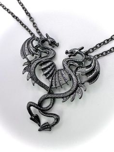 2 piece dragon couples necklaces! Two dragon necklaces that are gunmetal black 18" long chains and their tails intertwine to form a heart shape. Beautiful gift for you and your special someone or best friend! Comes in one black gift box and a beautiful moon & star mesh bag (see photos). Dragons are approx 2 inches tall by .5 inches wide. See photos  If you would like a specific-colored moon bag, please message me and I will complete your request if it is available.  Color options - Dark blue, bl Black Metal Fantasy Jewelry, Black Metal Fantasy Necklace, Black Fantasy Pendant Necklace, Fantasy Black Pendant Necklace, Black Fantasy Necklace For Gift, Black Adjustable Fantasy Necklace, Fantasy Style Adjustable Black Necklace, Fantasy Style Black Necklace, Dragon Necklaces