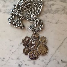 "This vintage SiLVER COIN MEDALLiON NECKLACE has 7 (faux) coins of  San Marc Ven,  Dalma BT Alban and Ulyses (Ulysses).  They are soldered together and hang from a thick textured curb chain, 30\" long.  It's an interesting piece and in good condition.  The chain is FABULOUS.  ✦  MARKS AND MATERIALS: No makers mark. coins are marked:  San Marc Ven,  Dalma BT Alban and Ulyses.  Silver tone metal.  Textured curb chain.  ✦ CONDITION:  This VINTAGE  is in GOOD vintage condition.  I believe the origin Medallion Necklace, Silver Coin, Dry Brushing, Coin Necklace, Vintage Bracelets, Silver Coins, Curb Chain, Jewellery Display, Tucson