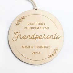 a wooden ornament with the words our first christmas as grandparents and mimi & grandad