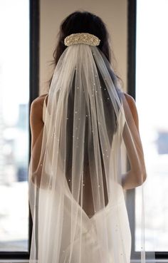 the back of a woman wearing a veil