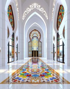 an ornate hallway with stained glass windows and colorful floor tiles on the walls, along with arched doorways