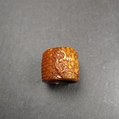 a carved wooden ring sitting on top of a table