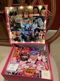 a pink box filled with lots of candy and candies on top of a table